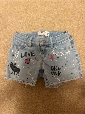 abercrombie kids light blue denim shorts with painted graphics